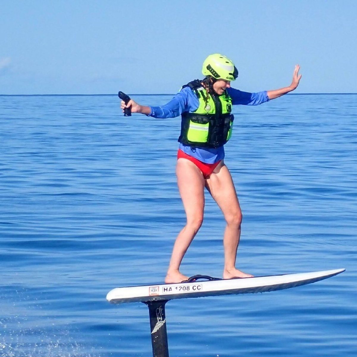 a woman riding a board on a body of water