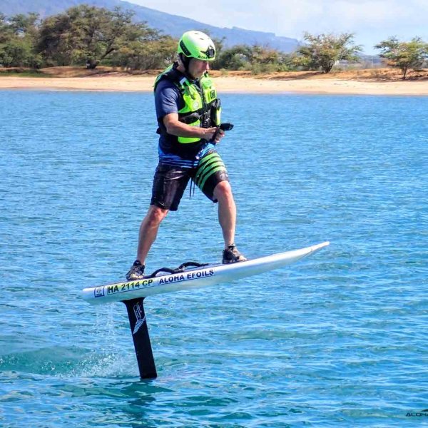 a man riding a board on a body of water