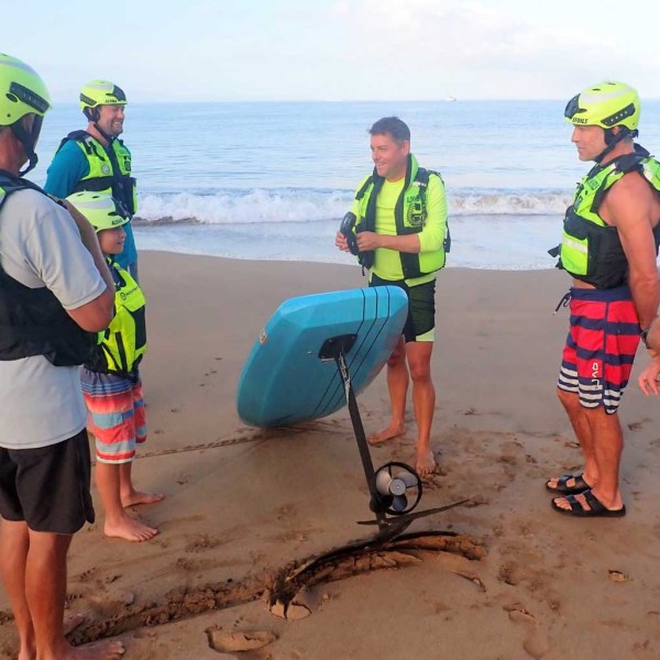 a group of people standing on a beach