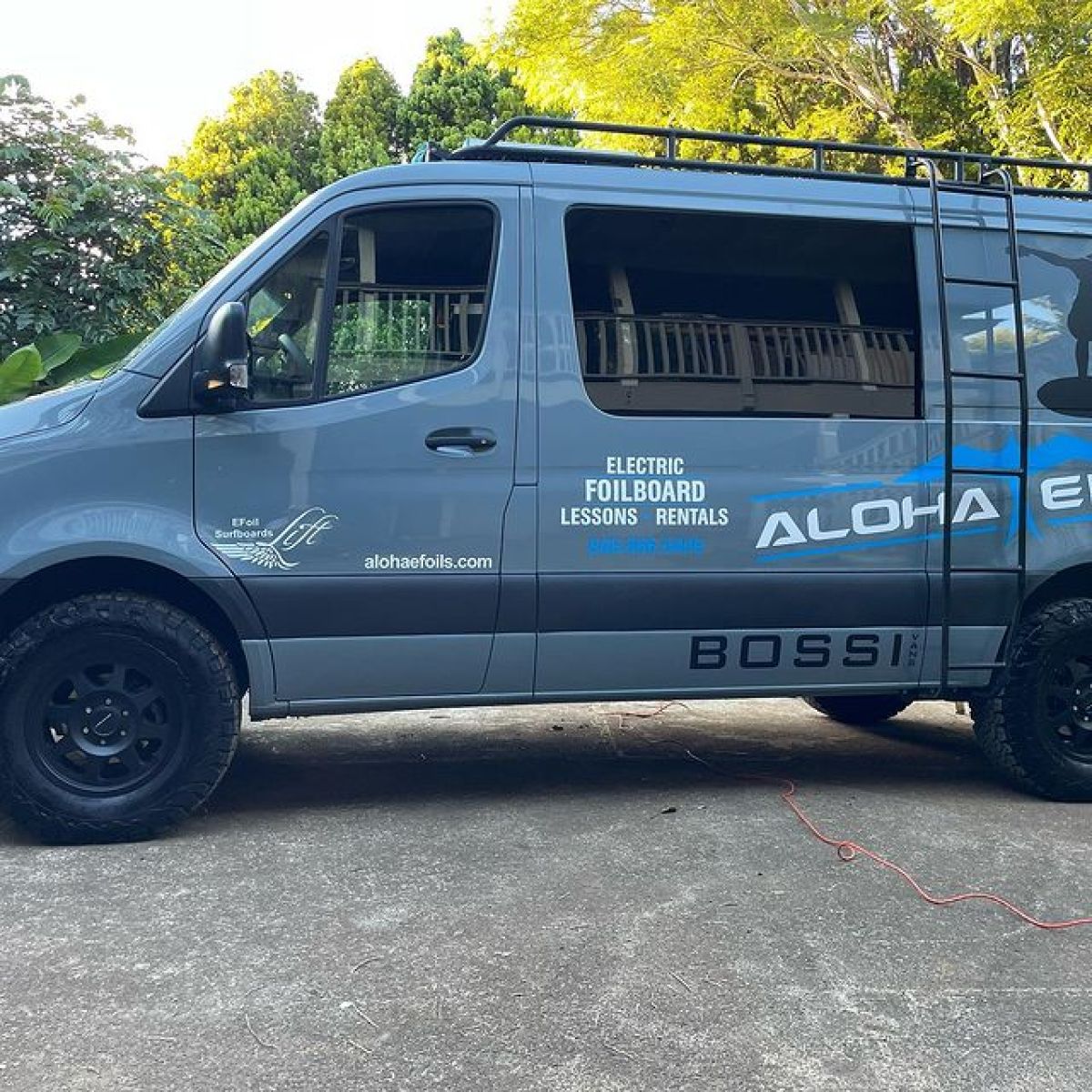 a blue bus parked in front of a car